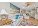 Bright living room with cozy seating, beach-themed decor, and an open layout to the kitchen and dining area at 3701 Docksite Rd # 220, Edisto Island, SC 29438
