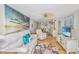 Inviting living room with sofa, TV, beach-themed art, and seamless flow to the kitchen and dining area at 3701 Docksite Rd # 220, Edisto Island, SC 29438