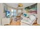 Comfortable living room features cozy seating, ceiling fan, and a scenic view from the private balcony at 3701 Docksite Rd # 220, Edisto Island, SC 29438