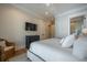 Bedroom featuring a white king bed, side chair, and dresser, with a wall-mounted television at 3803 Palm Blvd, Isle of Palms, SC 29451