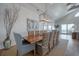 Elegant dining room with a large wood table, stylish lighting, and coastal-inspired decor at 3803 Palm Blvd, Isle of Palms, SC 29451