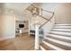 Inviting foyer with beautiful hardwood floors, a staircase, a modern chandelier, and access to the living room at 3803 Palm Blvd, Isle of Palms, SC 29451