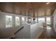 Hallway with wood floors, a staircase, decorative light fixture, and scenic window views at 3803 Palm Blvd, Isle of Palms, SC 29451