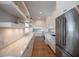 Spacious laundry room featuring extensive cabinetry, marble counters, and stainless steel appliances at 3803 Palm Blvd, Isle of Palms, SC 29451