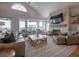Comfortable living area with large windows, stone fireplace, and cozy seating arrangement at 3803 Palm Blvd, Isle of Palms, SC 29451