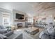 Cozy living room showcases a stone fireplace, large TV, and comfortable seating arrangement at 3803 Palm Blvd, Isle of Palms, SC 29451