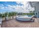 Beautiful outdoor swimming pool featuring wood deck, tropical trees, and nearby houses at 3803 Palm Blvd, Isle of Palms, SC 29451