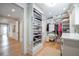 Organized walk-in closet with custom shelving for clothing, shoes, and extra storage space at 3803 Palm Blvd, Isle of Palms, SC 29451