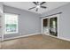 Bedroom with a ceiling fan, sliding glass doors to a balcony, and a window with green views at 4003 Radcliffe Place Dr # B6, Charleston, SC 29414