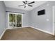 Bedroom features a ceiling fan, television, and sliding glass doors to a balcony with green views at 4003 Radcliffe Place Dr # B6, Charleston, SC 29414