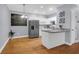 Bright kitchen featuring white cabinets, stainless steel appliances, granite countertops, and hardwood floors at 4003 Radcliffe Place Dr # B6, Charleston, SC 29414