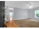 Spacious living room with hardwood flooring at entry and carpet, ceiling fan, and natural light at 4003 Radcliffe Place Dr # B6, Charleston, SC 29414