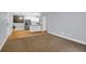 Bright living room with hardwood and carpeted floor, featuring white cabinets and stainless steel appliances at 4003 Radcliffe Place Dr # B6, Charleston, SC 29414