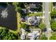 Aerial view of a residential neighborhood featuring houses, mature trees, and a pond with a fountain at 4009 E Amy Ln, Johns Island, SC 29455