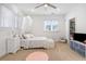 Cozy bedroom with white bedding, carpeted floors, ceiling fan and natural light from the window at 4009 E Amy Ln, Johns Island, SC 29455