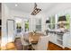 Bright dining room featuring wood floors, wainscoting and access to an outdoor space at 4009 E Amy Ln, Johns Island, SC 29455