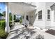 Home featuring a covered driveway, white siding, and lush landscaping at 4009 E Amy Ln, Johns Island, SC 29455