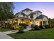 Stunning two-story white home featuring a welcoming front porch and beautifully landscaped front yard at 4009 E Amy Ln, Johns Island, SC 29455