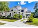 Charming two-story white home with a welcoming front porch and a spacious driveway at 4009 E Amy Ln, Johns Island, SC 29455