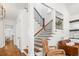 Open foyer with hardwood floors, staircase with wood railing, and a comfortable chair for relaxing at 4009 E Amy Ln, Johns Island, SC 29455