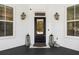 Charming front entry boasts a black door, lantern sconces, and stylish decor at 4009 E Amy Ln, Johns Island, SC 29455