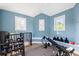Home gym features blue walls, two windows, and workout equipment at 4009 E Amy Ln, Johns Island, SC 29455