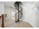 Hallway featuring a black spiral staircase with white trim and carpeted floors at 4009 E Amy Ln, Johns Island, SC 29455