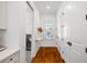 Hallway featuring beautiful tile floors, laundry room access, and ample closet space at 4009 E Amy Ln, Johns Island, SC 29455