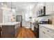 Well-equipped kitchen with white cabinets, stainless steel appliances, and hardwood floors at 4009 E Amy Ln, Johns Island, SC 29455