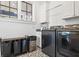 Functional laundry room with modern appliances, patterned floor tiles, and natural light at 4009 E Amy Ln, Johns Island, SC 29455