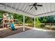 Covered patio overlooking a wooden playground with lush greenery in the background at 4009 E Amy Ln, Johns Island, SC 29455