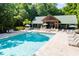 Resort style pool area with lounge chairs, pool umbrellas, and a covered pavilion at 4009 E Amy Ln, Johns Island, SC 29455