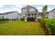 Home backyard with a green lawn, a palm tree, and lush landscaping in a serene outdoor setting at 4129 Maidstone Dr, Mount Pleasant, SC 29466