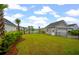 Large backyard with tropical landscaping overlooking a pond at 4129 Maidstone Dr, Mount Pleasant, SC 29466