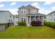 Beautiful home backyard featuring a spacious lawn and screened-in porch, perfect for outdoor relaxation at 4129 Maidstone Dr, Mount Pleasant, SC 29466