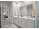 Well-lit bathroom showcasing a double vanity and neutral colored tiling at 4129 Maidstone Dr, Mount Pleasant, SC 29466