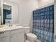 Bright bathroom featuring a white vanity and a stylish blue, layered shower curtain at 4129 Maidstone Dr, Mount Pleasant, SC 29466