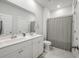 Bright bathroom features double sinks, tile floor, a toilet, and a walk-in shower at 4129 Maidstone Dr, Mount Pleasant, SC 29466