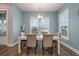 Bright dining room with a wooden table, neutral-colored chairs, and windows providing natural light at 4129 Maidstone Dr, Mount Pleasant, SC 29466