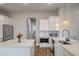 Bright, modern kitchen with stainless steel appliances, white cabinets, quartz countertops and wood flooring at 4129 Maidstone Dr, Mount Pleasant, SC 29466