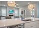 Bright, open-concept kitchen with a large island, white cabinets, stainless appliances, and view of the living area at 4129 Maidstone Dr, Mount Pleasant, SC 29466