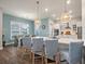 Kitchen island with pendant lights, breakfast bar seating, quartz countertop, and view of the dining area at 4129 Maidstone Dr, Mount Pleasant, SC 29466