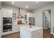 Modern kitchen featuring stainless steel appliances, white cabinets, quartz countertops and wood flooring at 4129 Maidstone Dr, Mount Pleasant, SC 29466