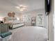 Bright main bedroom featuring a sitting area, balcony access, and decorative wall art at 4129 Maidstone Dr, Mount Pleasant, SC 29466