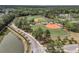 High aerial view of community baseball field with beautiful green grass, set with trees and roadway nearby at 4235 Scharite St, Charleston, SC 29414
