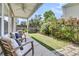 Relaxing back patio with seating, decorative plants, and a manicured lawn and garden at 4235 Scharite St, Charleston, SC 29414