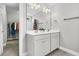 Bathroom featuring double sink vanity, large mirror, and shower-tub with decorative curtain at 4235 Scharite St, Charleston, SC 29414