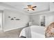 Bright bedroom with large windows, neutral color scheme, carpet flooring, and ceiling fan at 4235 Scharite St, Charleston, SC 29414