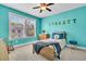 Bright bedroom featuring colorful accents, a ceiling fan, and a window with a view at 4235 Scharite St, Charleston, SC 29414