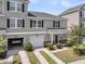 Attractive townhome showcases a two-car garage and well-maintained landscaping enhancing curb appeal at 4235 Scharite St, Charleston, SC 29414